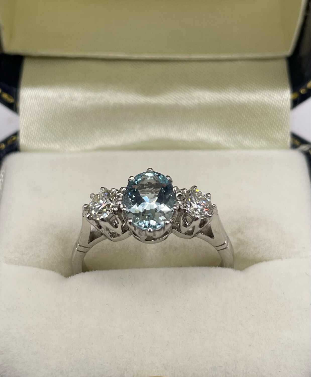 Platinum Three Stone Ring With 1ct Oval Central Aquamarine And .50ct Of Brilliant Cut Diamonds In A Claw Setting