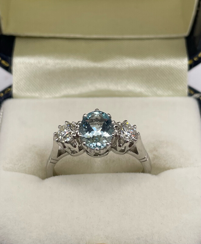 Platinum Three Stone Ring With 1ct Oval Central Aquamarine And .50ct Of Brilliant Cut Diamonds In A Claw Setting