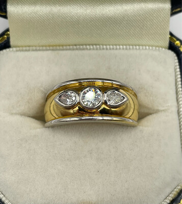 18ct Yellow And White Gold Band Ring With Central Brilliant Cut Diamond And Two Pear Cuts.