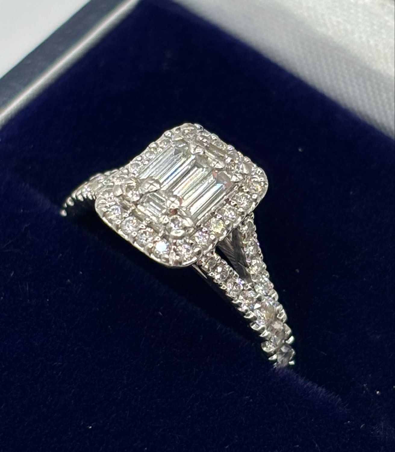 Platinum Halo Ring With .70ct Brilliant & Baguette Cut Diamonds With Diamond Shoulders.