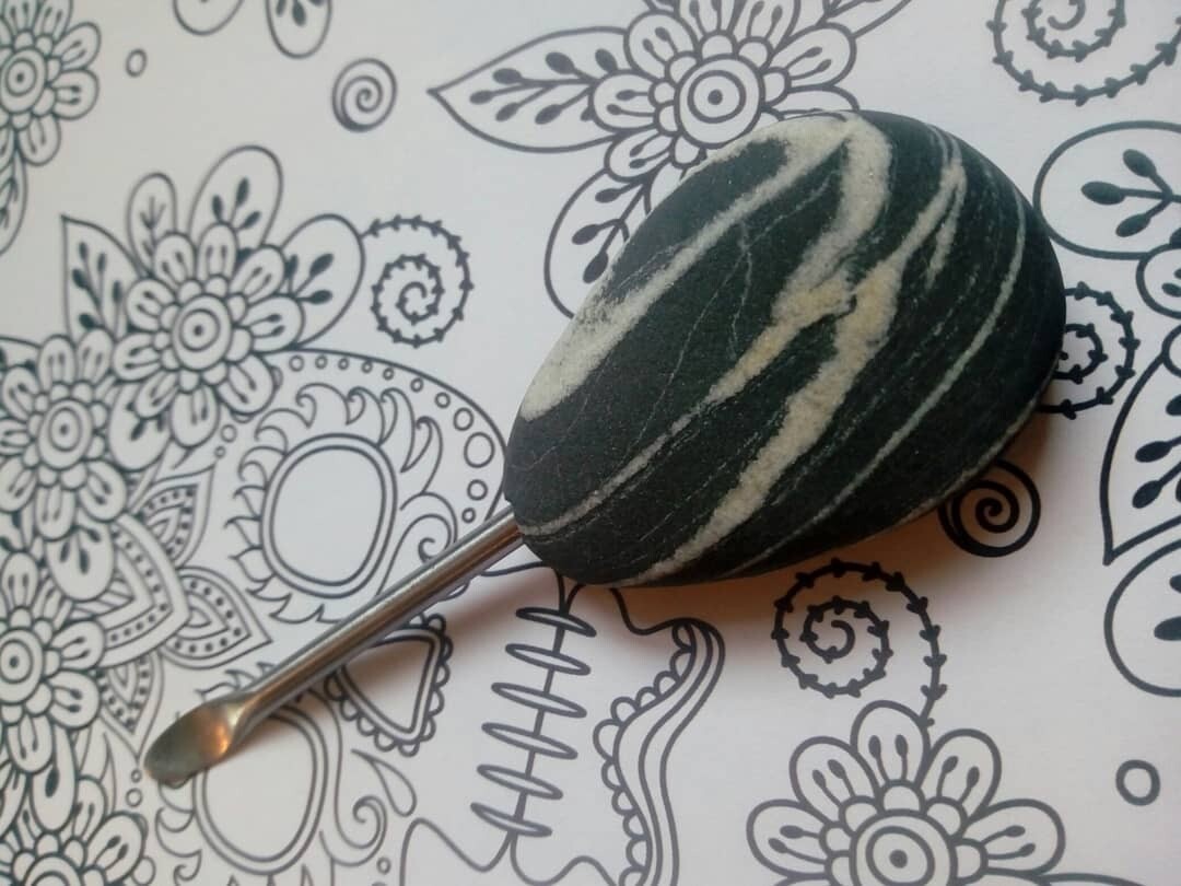 Quartz veined basalt handle with carbon steel tool.