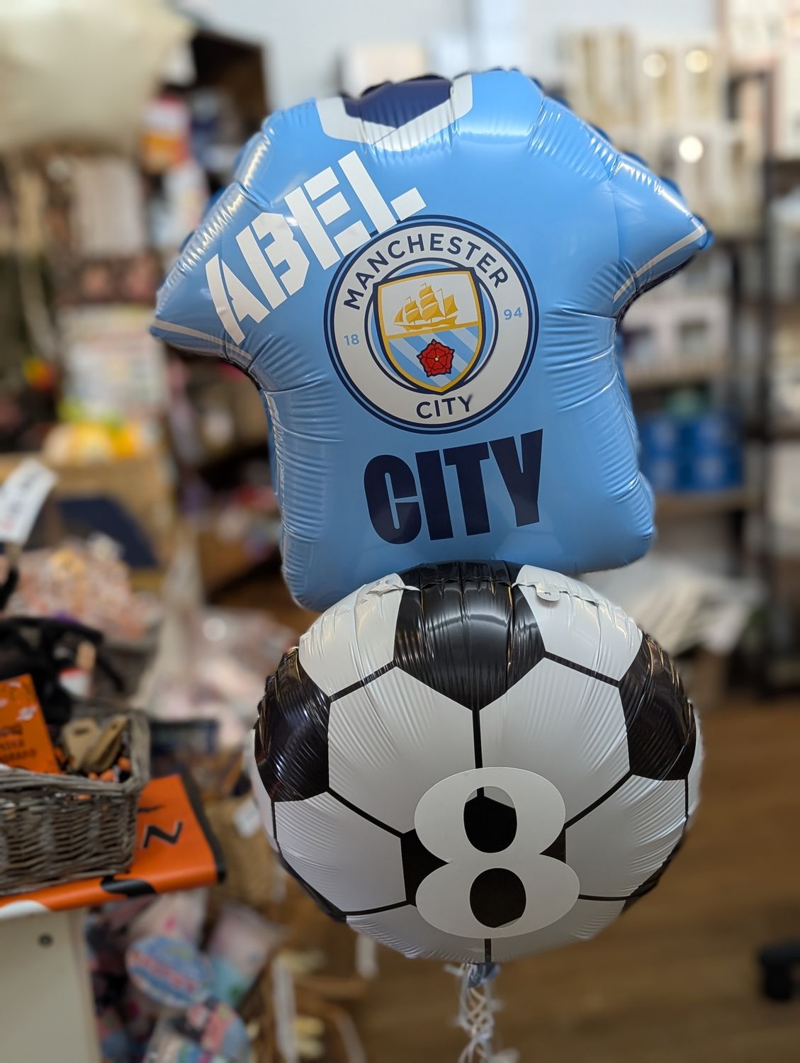 Manchester city football shirt and foil balloon