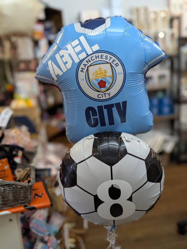 Manchester city football shirt and foil balloon
