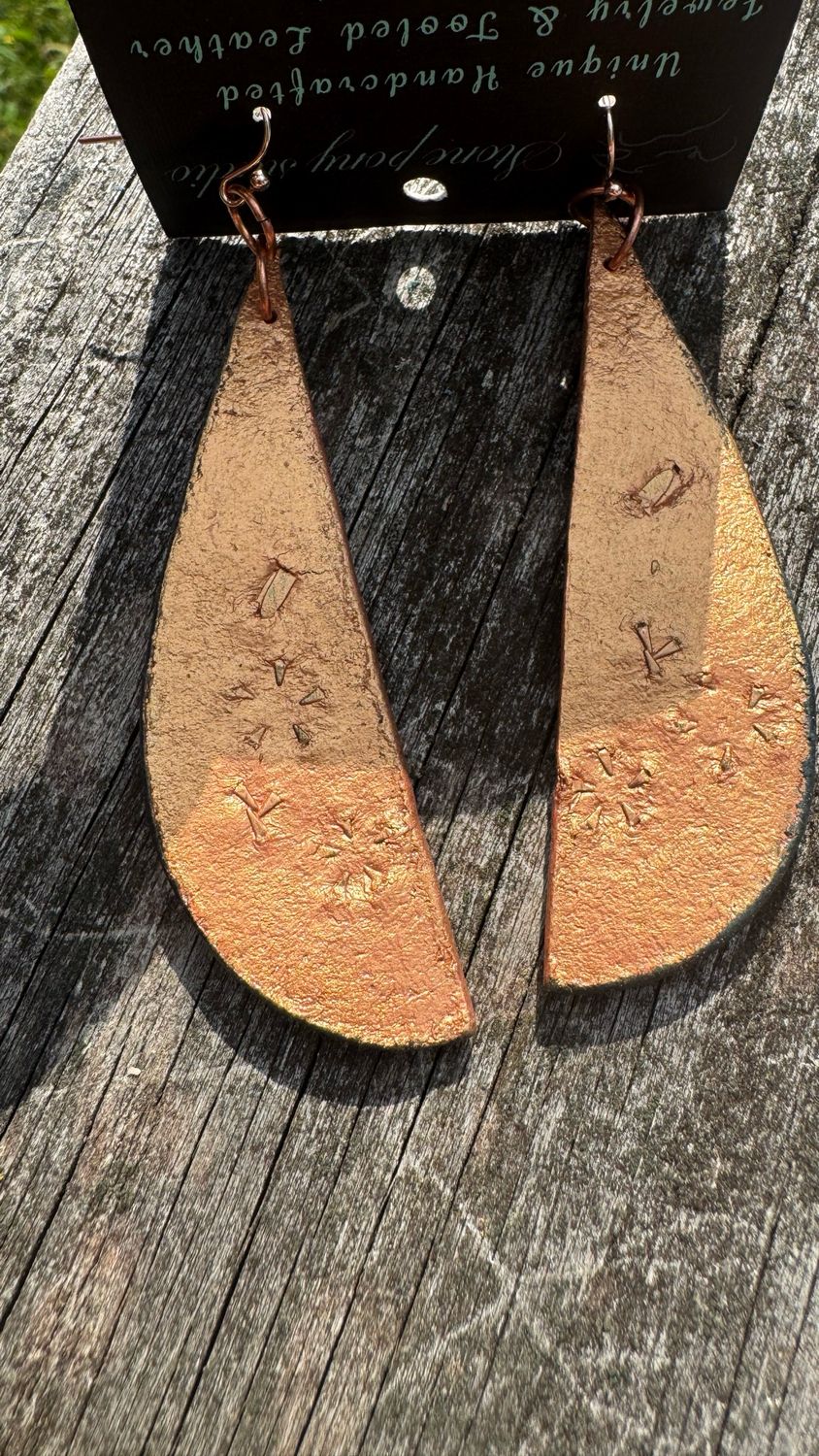 Hand tooled and painted leather earrings. Olive and Gold Tone Painted Daisy Type Flowers with a painted Metallic Gold back. Approx 4” Length Including Hypoallergenic Earwires.