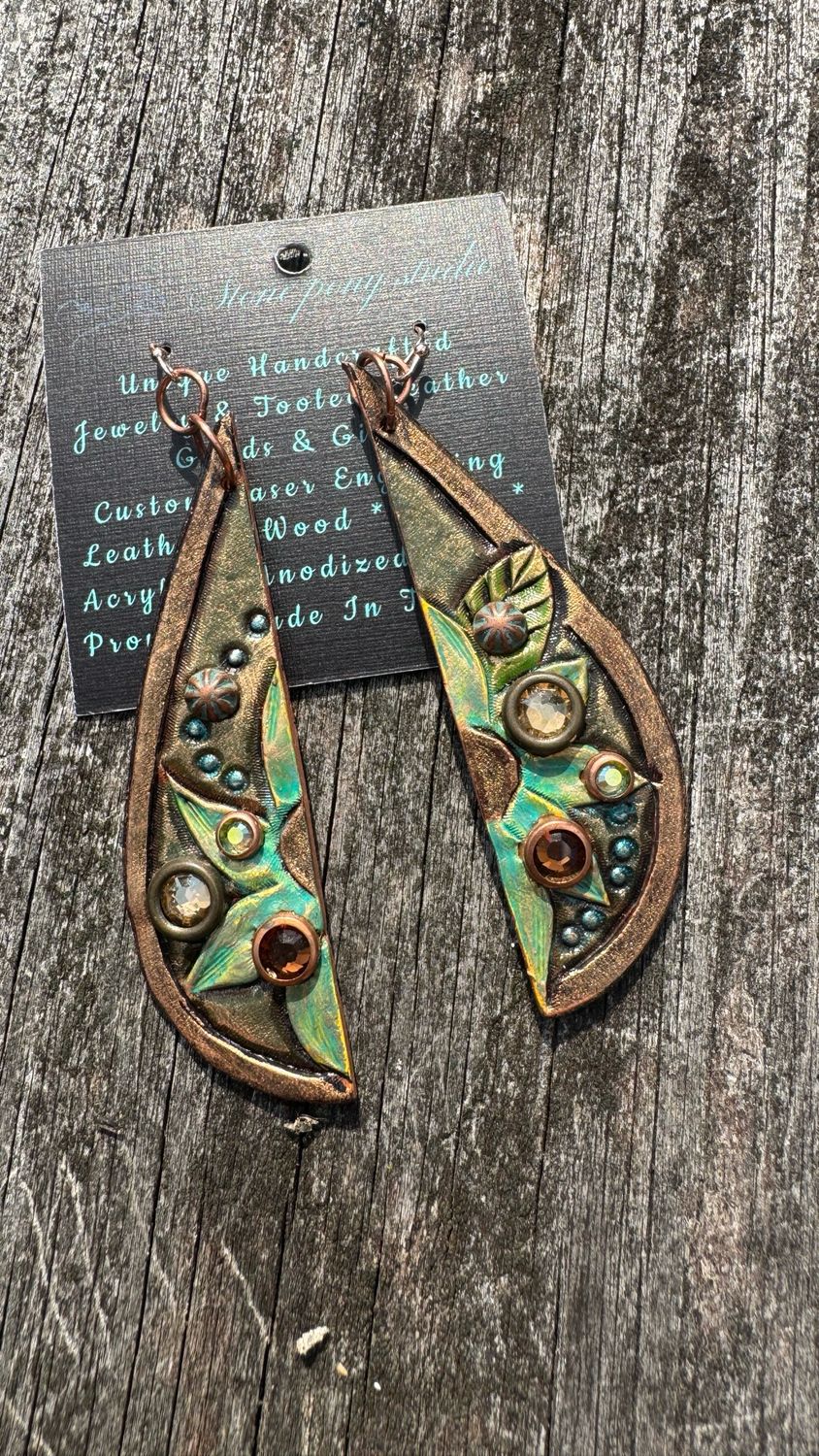 Hand tooled and painted leather earrings.  Olive and Gold Tone Painted Daisy Type Flowers with a painted Metallic Gold back.  Approx 4” Length Including Hypoallergenic Earwires.