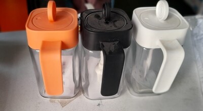 Oil jar with dispensing spoon & coloured lid. Honey dispenser