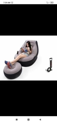 Inflatable seat with footrest and pump