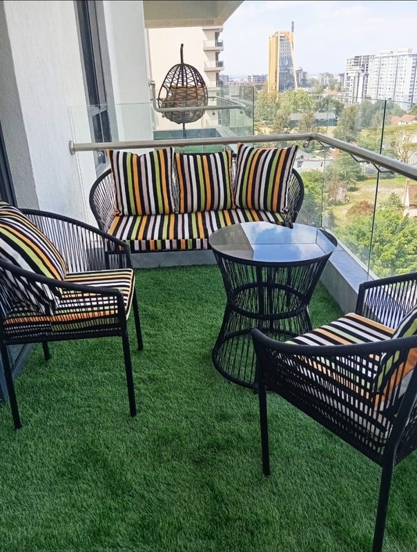 Vibrant Modern Woven Outdoor Sofa Set with Striped Cushions and Glass Coffee Table
