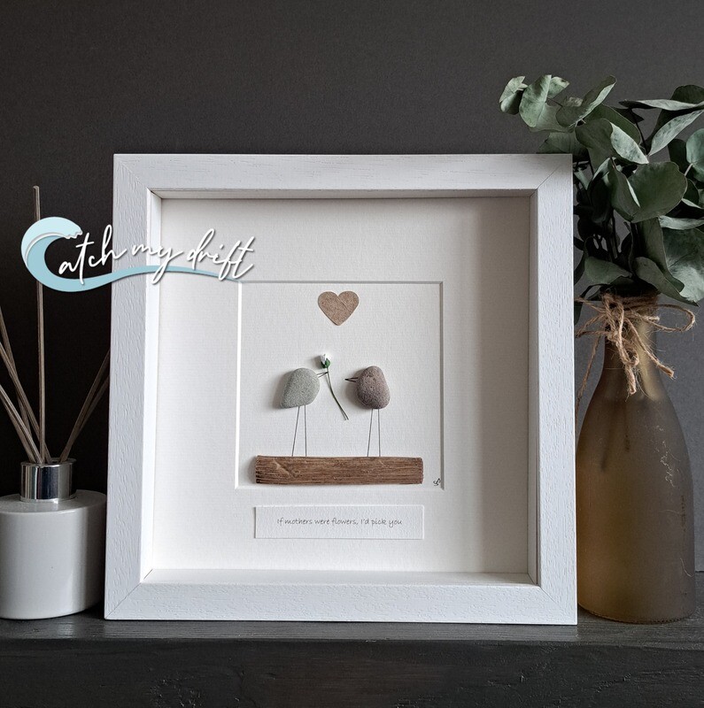 2 pebble birds on a wooden perch under a paper heart. One holding a flower with the quote &quot;if mother&#39;s were flowers I&#39;d pick you&quot;