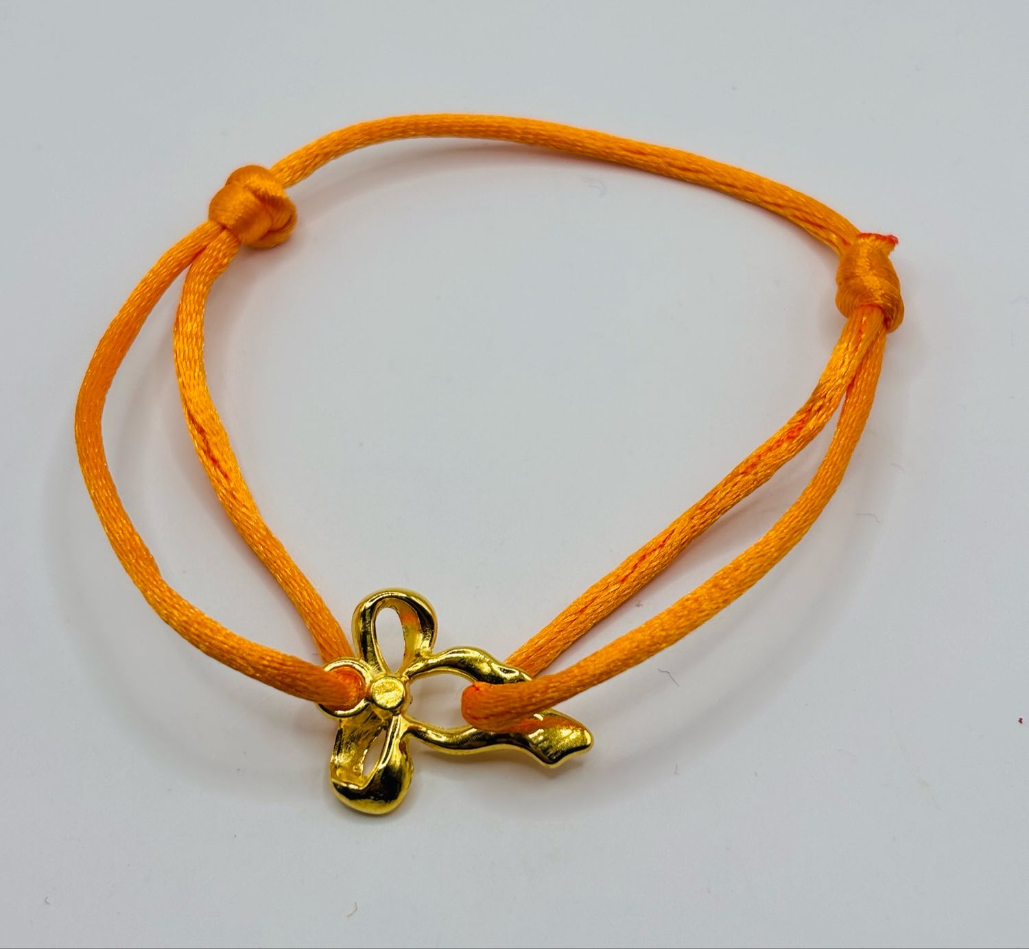 Satinarmbandje strik goud