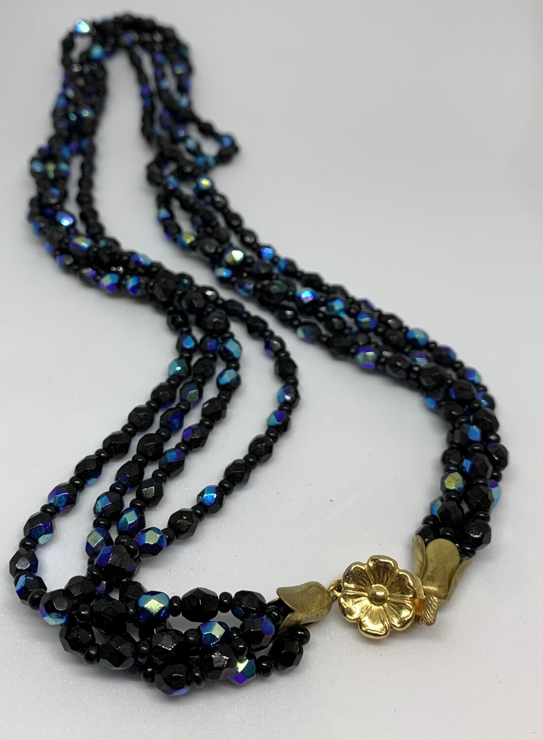 Blue Glass Four Layer Necklace With Gold Flower Clasp