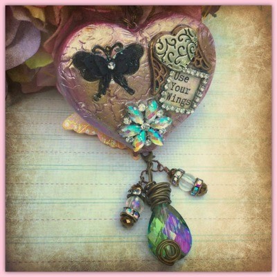 "Use Your Wings" - Clay and metal mixed media heart, butterfly, winged heart and crystal flower necklace with "Use Your Wings" sealed in the heart.