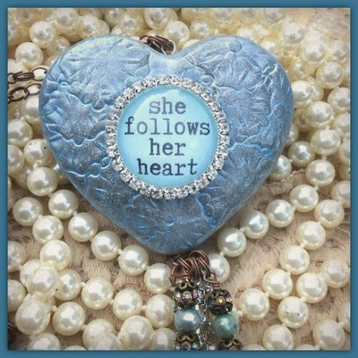 "she follows her heart" - Clay, mixed media heart with "she follows her heart" in center cabochon