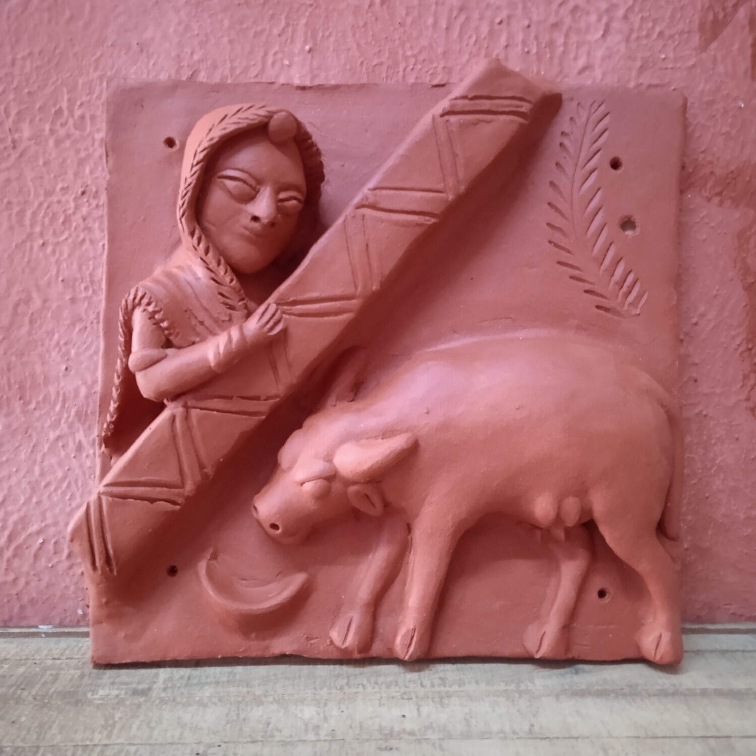 Terracotta woman and a cow
