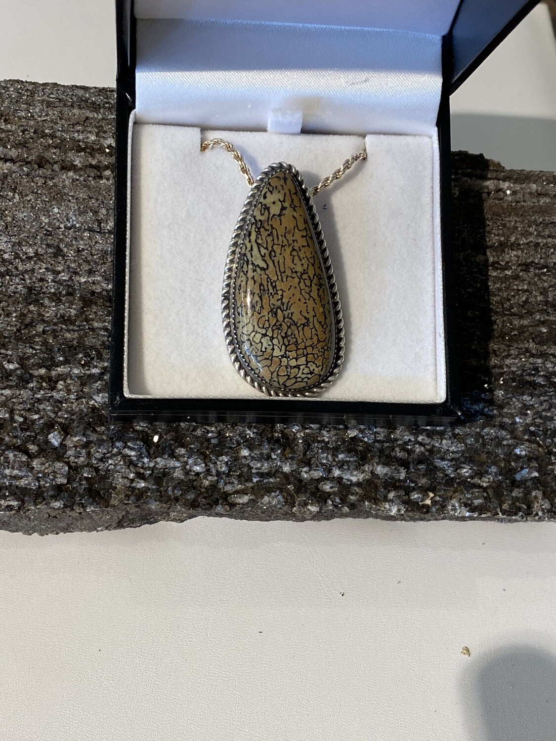 Camo colored dino bone pendant