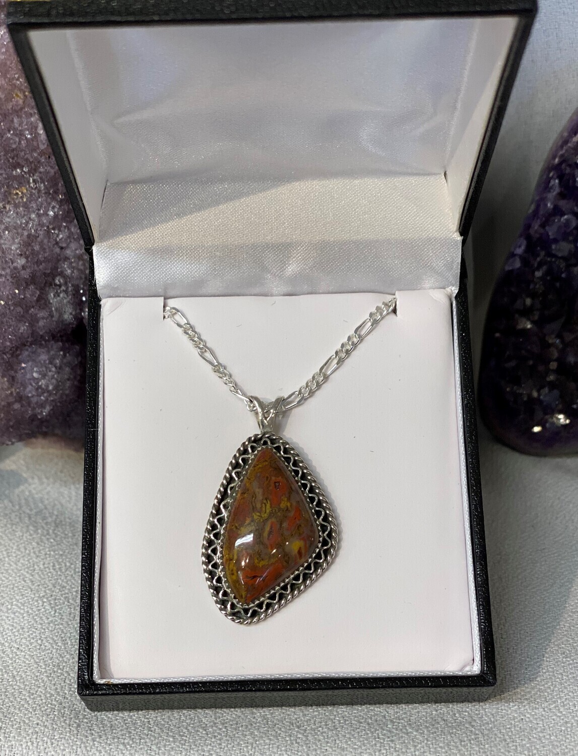 SOLD.  Red and yellow gem dino bone pendant