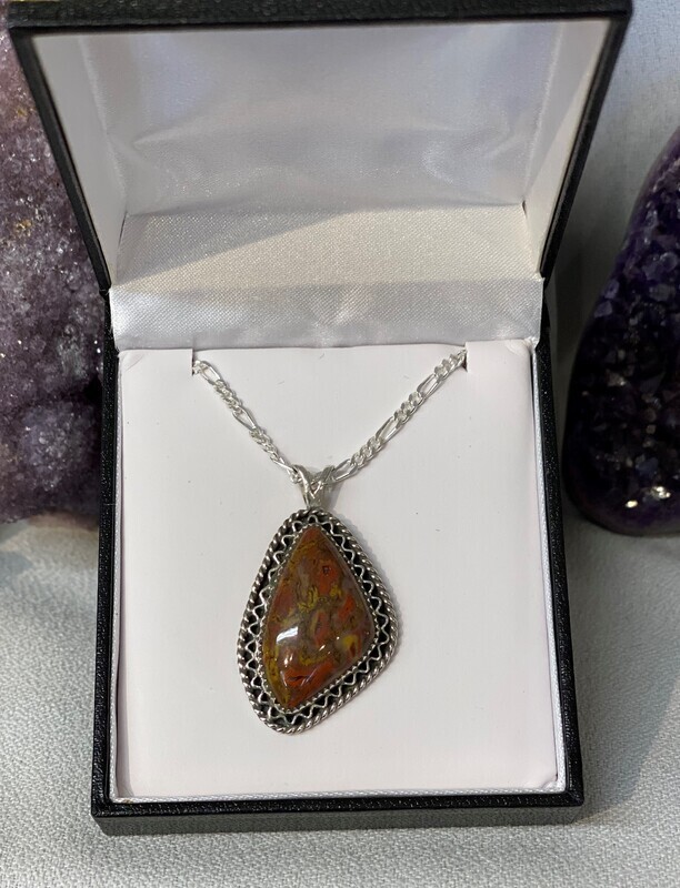 SOLD.  Red and yellow gem dino bone pendant