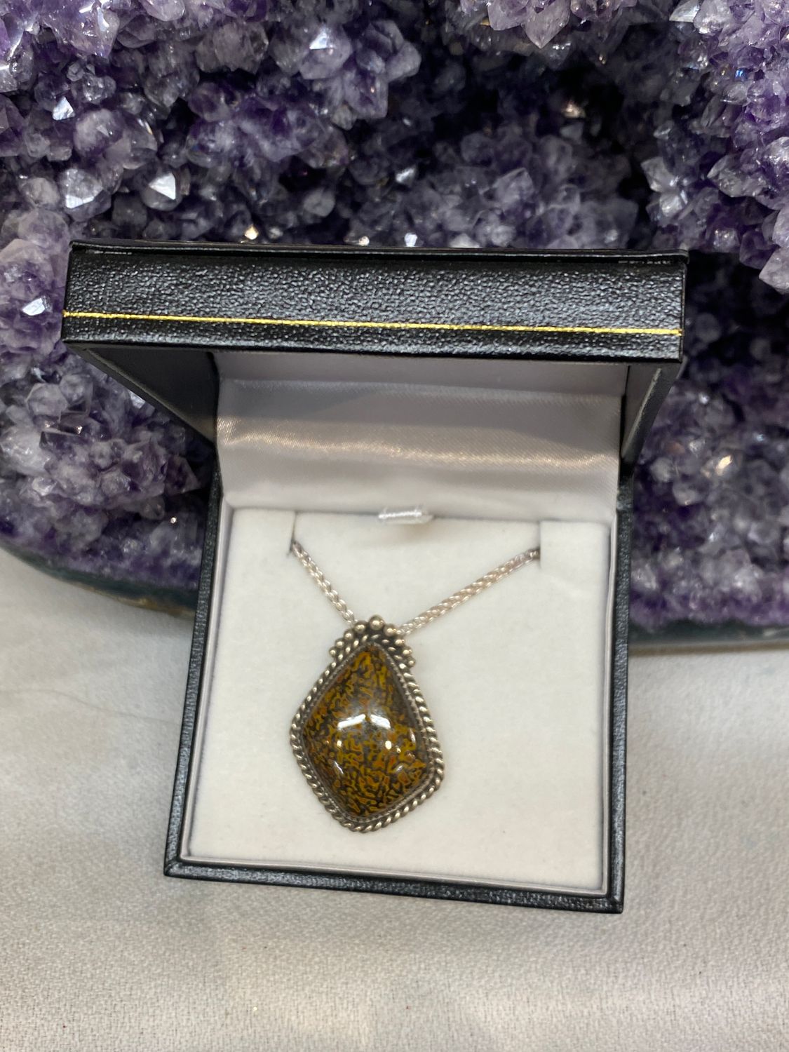 Rare yellow and red gem dino bone pendant