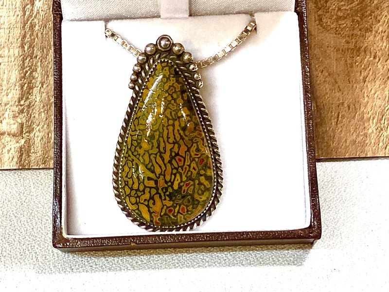 Rare red and yellow gem Dino bone pendant