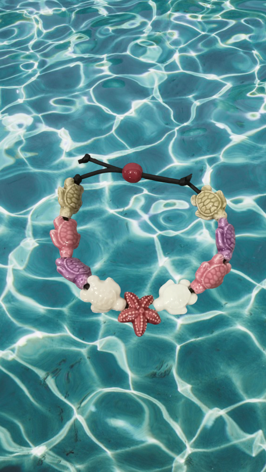 Bracciale tartarughe in ceramica colore beige,lilla,rosa chiaro,bianco. stella rosa scuro Bracciale tartarughe in ceramica colore beige,lilla,rosa chiaro,bianco. stella rosa scuro