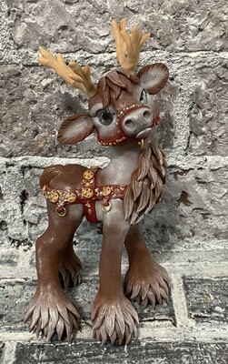 Brown Reindeer with harness for sled