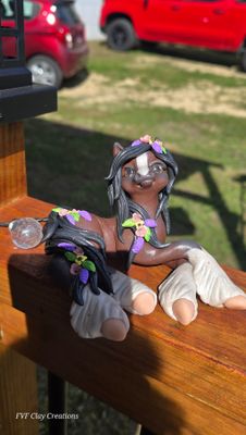 Bay flower pony laying down