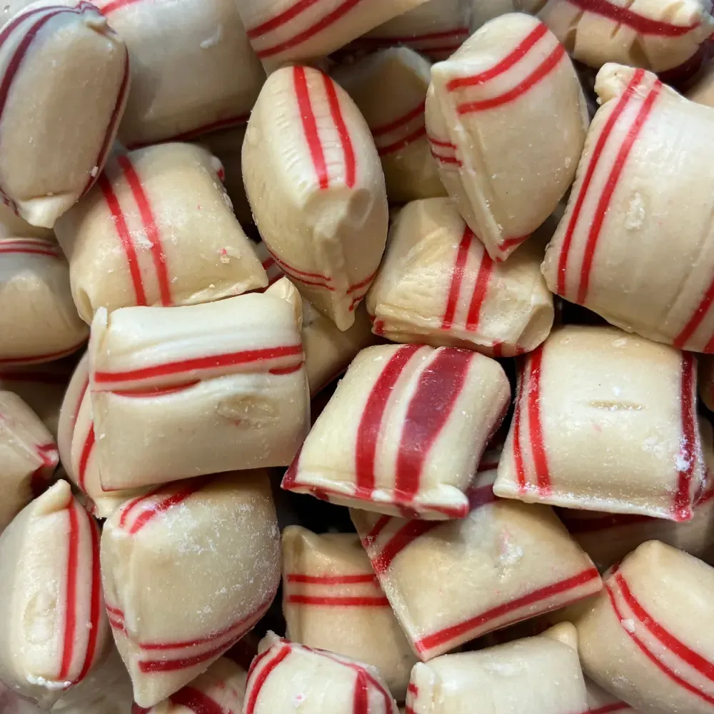 Temmerman cinnamon cushions, brown hard boiled sugar sweets in a cushion shape with a red stripe