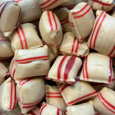 Cojines de canela de Temmerman, caramelos duros marrones con forma de cojín y una raya roja