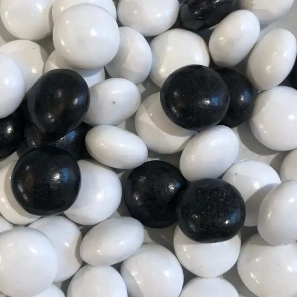 Temmerman salmiak, hard boiled liquorice sweet in white and black with a distinctive salty taste
