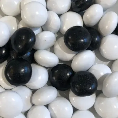 Temmerman salmiak, hard boiled liquorice sweet in white and black with a distinctive salty taste