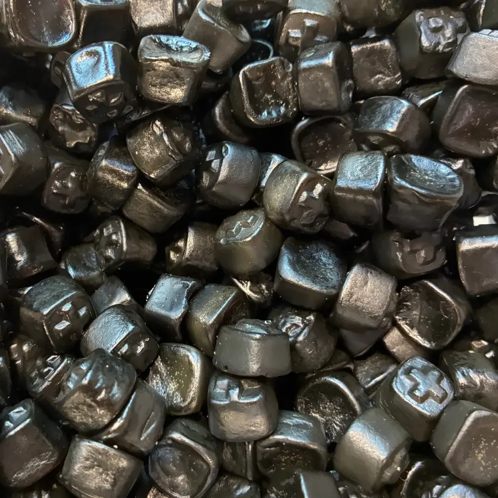 Temmerman liquorice crosses, black hard gums with mint flavour and a cross on the surface
