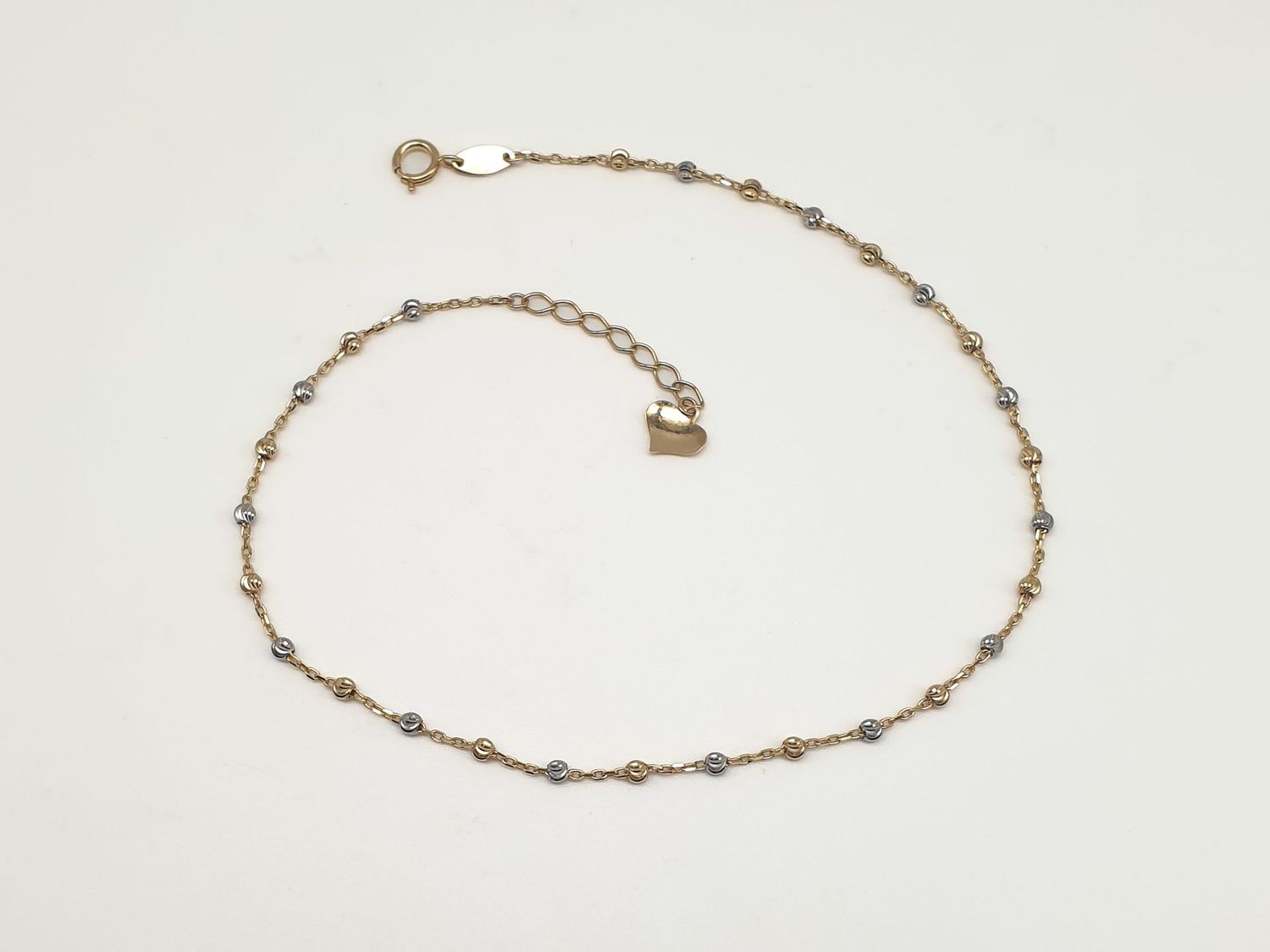 Cavigliera in oro 9ct “Sfere Luminose” Cavigliera in oro 9ct “Sfere Luminose”