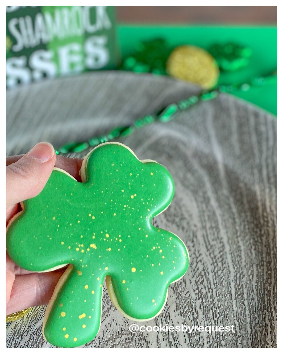 Individual gold speckled shamrock cookie