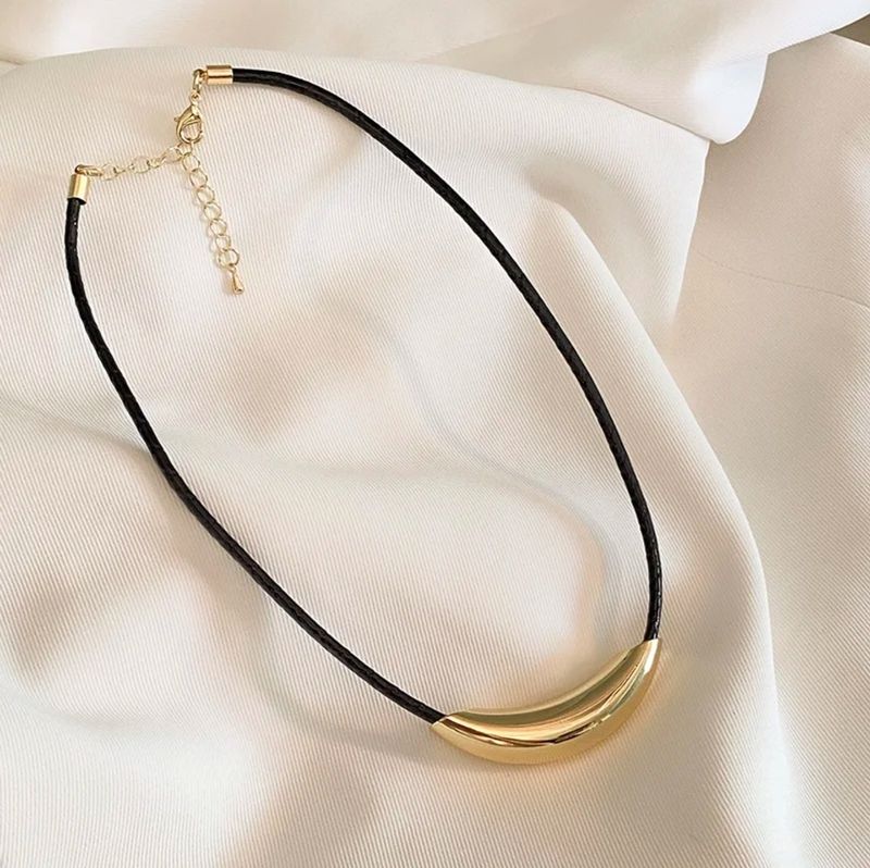 Gold bar in a rope necklace