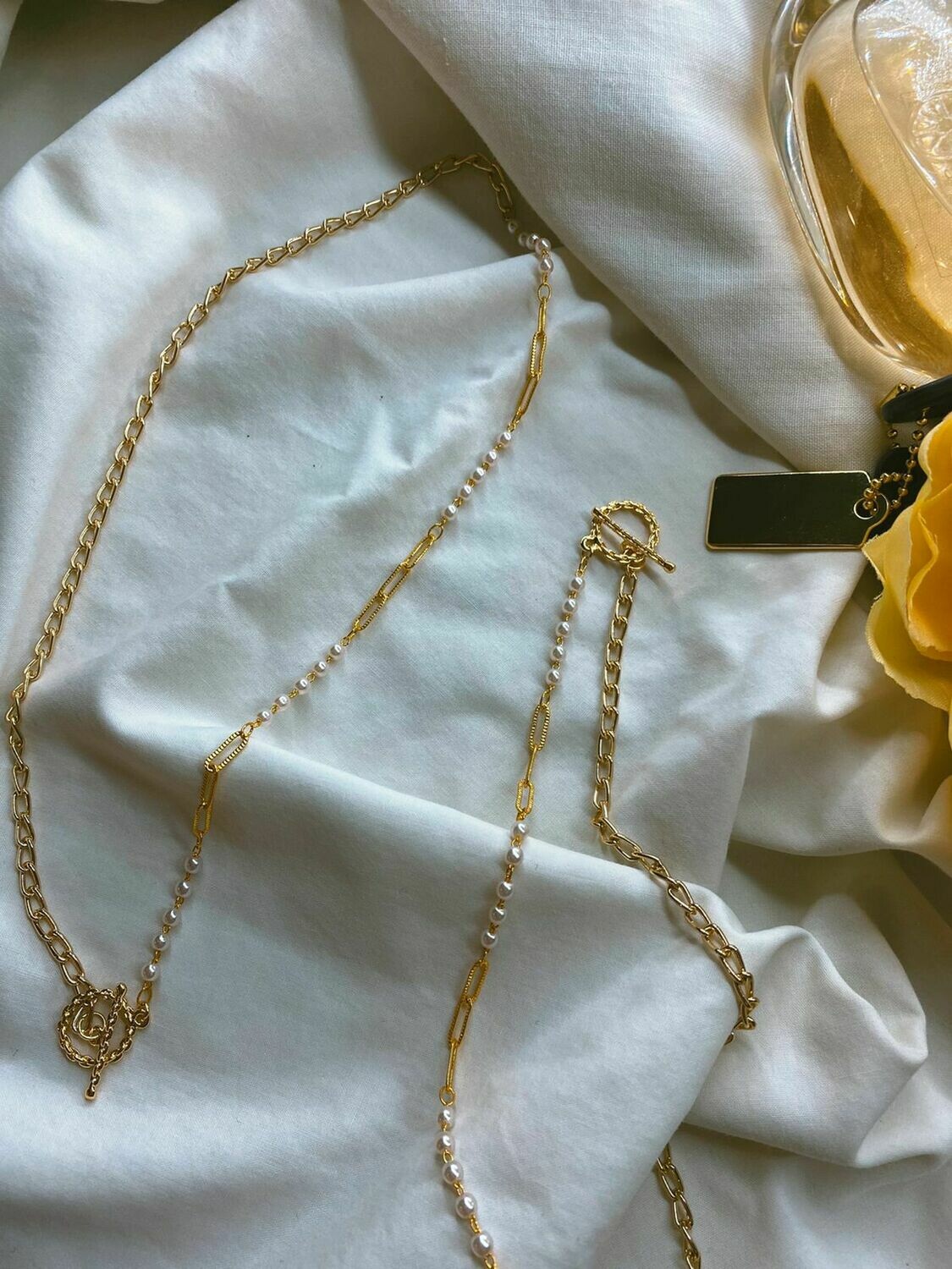 Pearl and gold skinny chain.