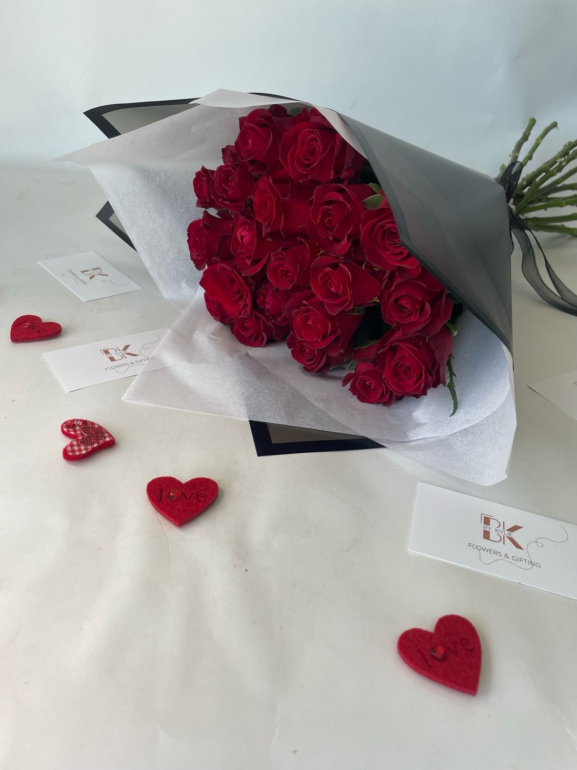 20 Classic Red Roses Hand Tied And Wrapped In Black Wrapping