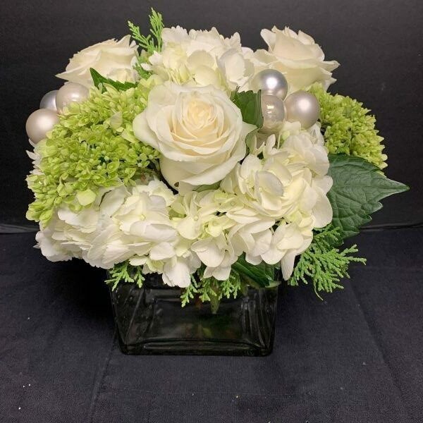 FestiveWhite and Green Arrangement in a  ClearGlass Cube Vase With Cedar and Baubles