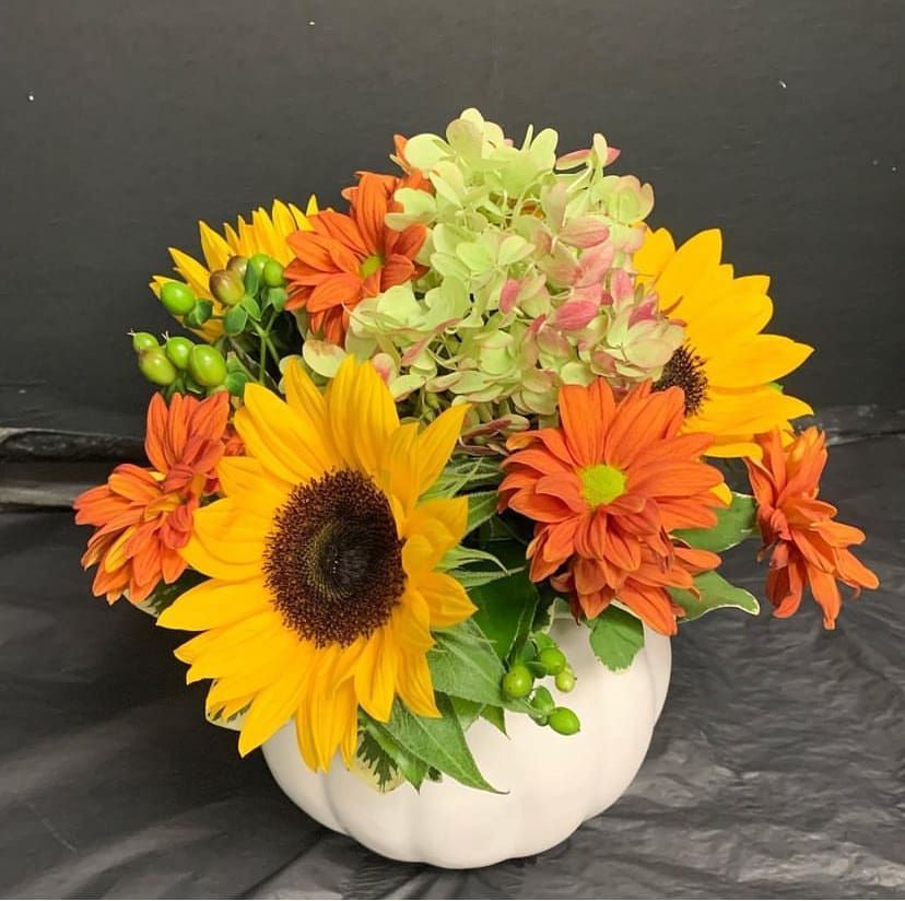 Sunflower arrangement in a white ceramic pumpkin