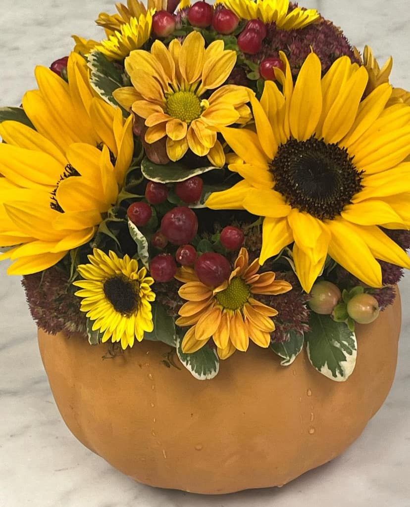Sunflower arrangement in an orange ceramic pumpkin