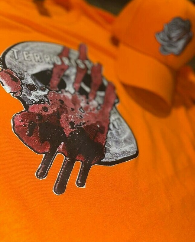 sturdy orange long sleeve terrorist t shirt with matching mur+less dad hat