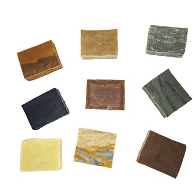 Rows of assorted soap bars displayed together, organized for gift pack presentation.