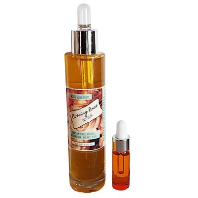 A large glass dropper bottle featuring a wraparound label, alongside a smaller pink glass dropper bottle with no label.