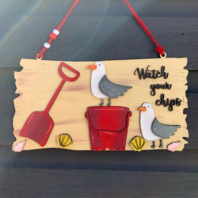 Hand painted ‘Watch Your Chips’ seagull bucket and spade driftwood hanging sign