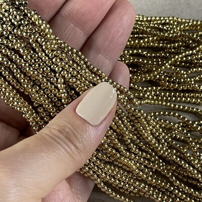 Piedra Sintética Hematite Redondo 2 mm Dorado Bañado Oro 18 K.