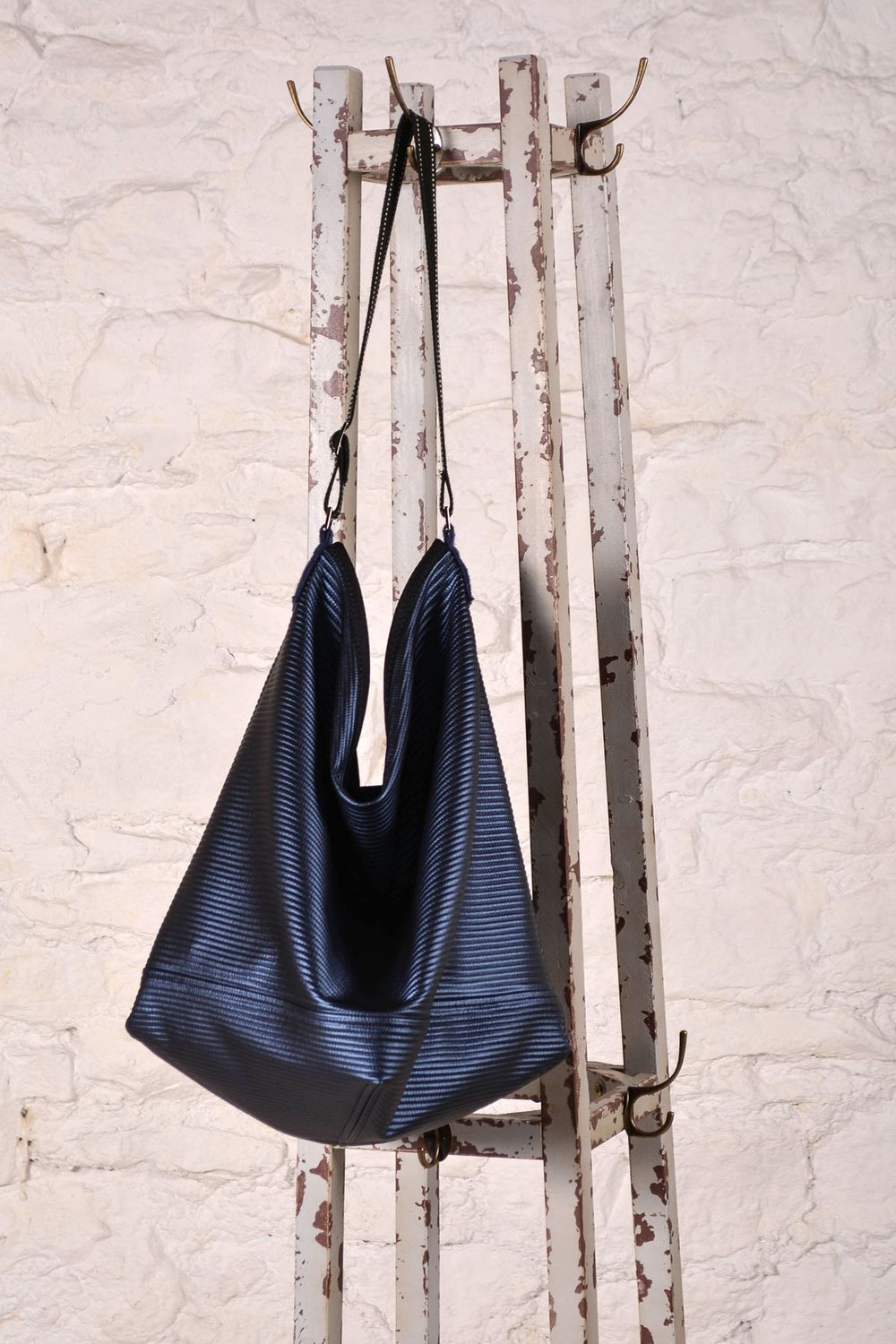 The Daily News bag made in black vinyl fabric. 