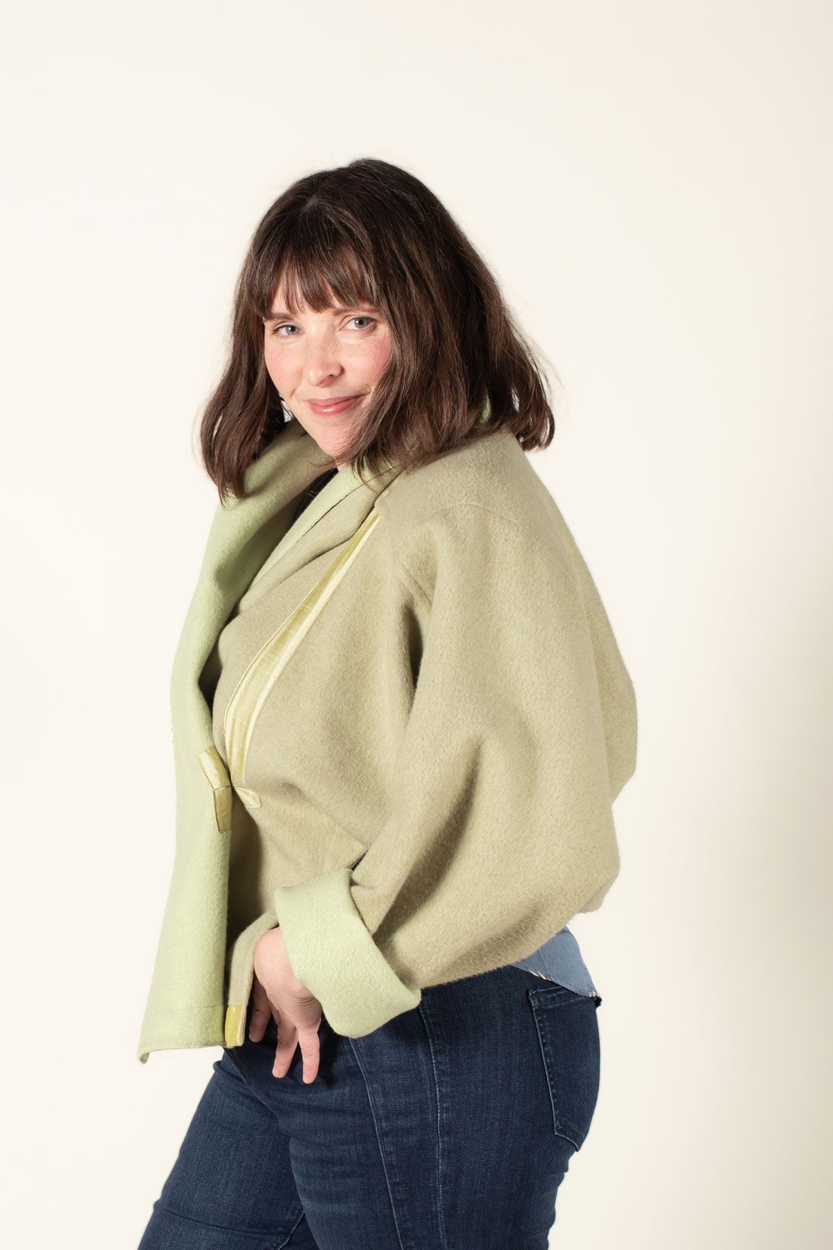 Side view of the Equinox made in a pear green double sided wool fabric.