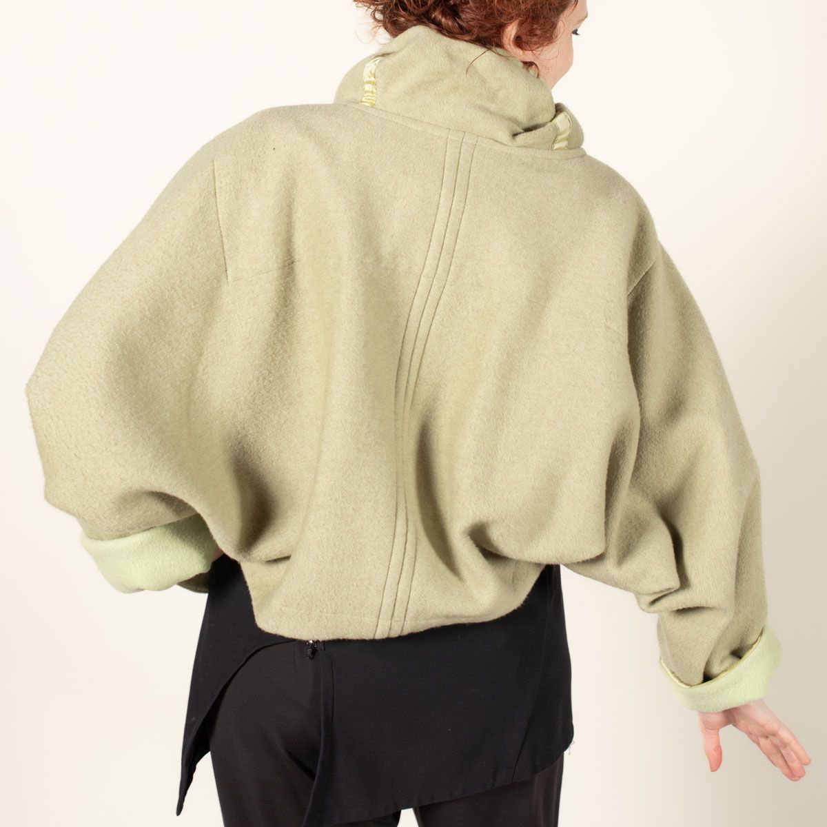 Back view of the Equinox made in a pear green double sided wool fabric.