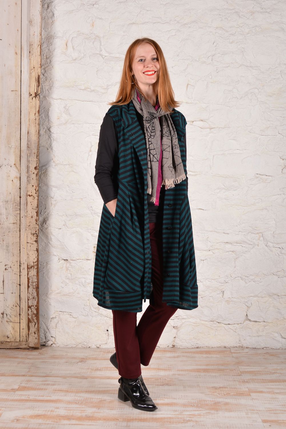 The Fillmore Duster made in a teal and black striped knit fabric, worn open as a long vest. 