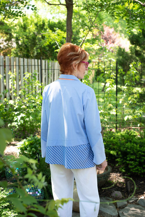 Back view of the Hibiscus Shirt made with three different blue shirting fabrics, and orange buttons. 