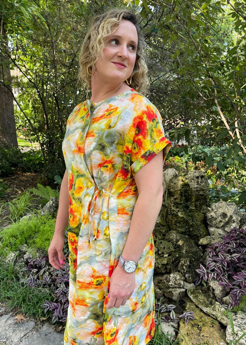 Side view of the Gardenia Dress made in a yellow and orange floral Ramie linen fabric.